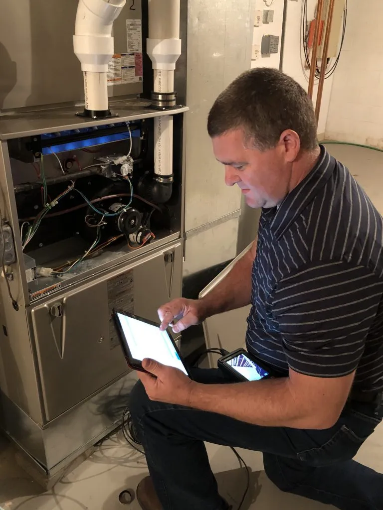 Perry Kieser reviewing a furnace inspection on his tablet